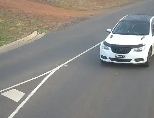 License plate recognition camera capturing vehicle number plate on road